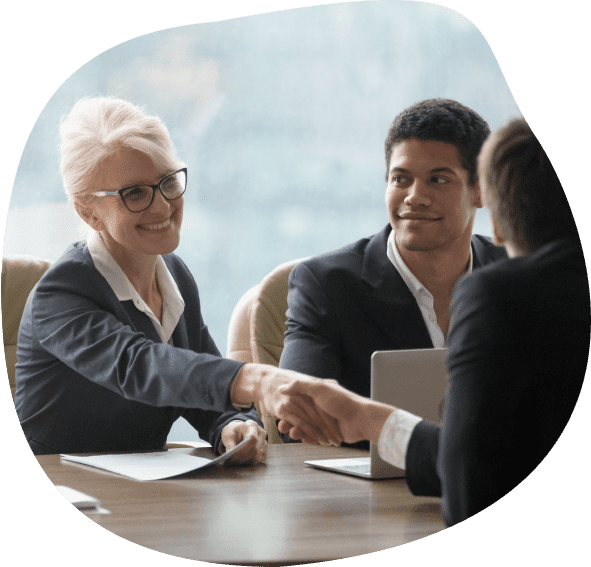 People shaking hands across a table